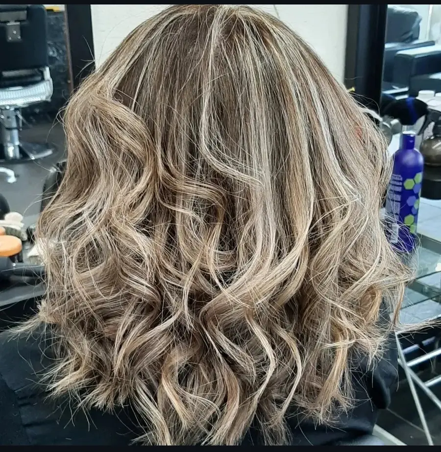Soft ash-blonde curls styled by MG Beauty Salon
