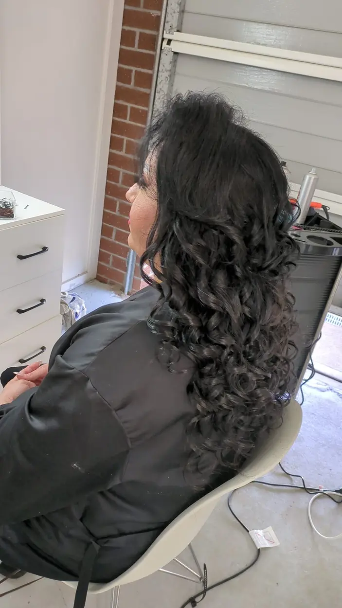 Long black curls finished by MG Beauty Salon