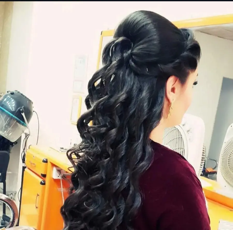 Long dark formal half-up hairstyle with curls